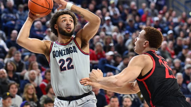 Dec 29, 2023; Spokane, Washington, USA; Gonzaga Bulldogs forward Anton Watson (22) shoots the ball against San Diego State Aztecs forward Elijah Saunders (25) in the first half at McCarthey Athletic Center. Mandatory Credit: James Snook-USA TODAY Sports
