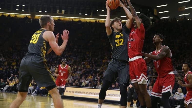 Iowa's Owen Freeman (32) drives to the basket against Northern Illinois Friday, Dec. 29, 2023 at Carver-Hawkeye Arena in Iowa City, Iowa.