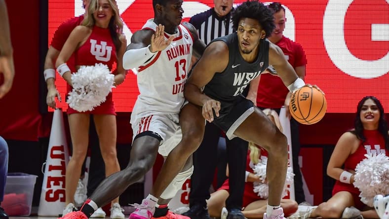 Dec 29, 2023; Salt Lake City, Utah, USA; Washington State Cougars forward Isaac Jones (13) dribbles around Utah Utes center Keba Keita (13) during the second half at the Jon M. Huntsman Center. Mandatory Credit: Christopher Creveling-USA TODAY Sports