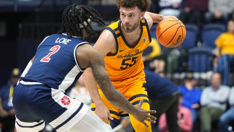 Dec 29, 2023; Berkeley, California, USA; California Golden Bears guard Devin Askew (55) handles the ball against Arizona Wildcats guard Caleb Love (2) during the first half at Haas Pavilion. Mandatory Credit: Darren Yamashita-USA TODAY Sports