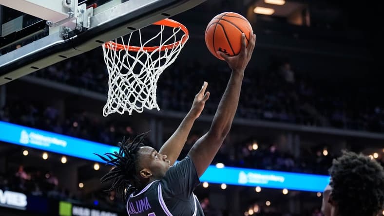 Dec 21, 2023; Kansas City, Missouri, USA; Kansas State Wildcats forward Arthur Kaluma (24) shoots against Wichita State Shockers forward Kenny Pohto (11) during the first half at T-Mobile Center. Mandatory Credit: Jay Biggerstaff-USA TODAY Sports