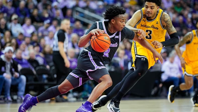Dec 21, 2023; Kansas City, Missouri, USA; Kansas State Wildcats guard Tylor Perry (2) dribbles the ball against Wichita State Shockers forward Ronnie DeGray III (3) during the second half at T-Mobile Center. Mandatory Credit: Jay Biggerstaff-USA TODAY Sports