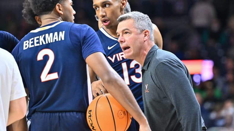 Dec 30, 2023; South Bend, Indiana, USA; Virginia Cavaliers head coach Tony Bennett talks to guard Reece Beekman (2) and guard Ryan Dunn (13) in the second half against the Notre Dame Fighting Irish at the Purcell Pavilion. Mandatory Credit: Matt Cashore-USA TODAY Sports