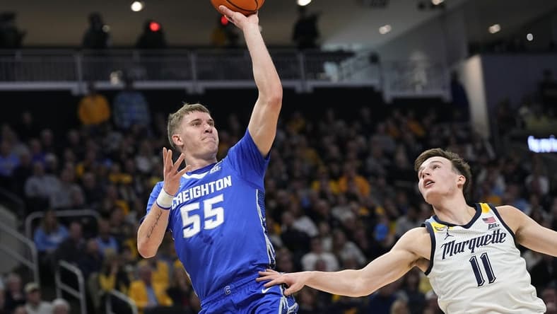 Dec 30, 2023; Milwaukee, Wisconsin, USA; Creighton Bluejays guard Baylor Scheierman (55) shoots over Marquette Golden Eagles guard Tyler Kolek (11) during the first half at Fiserv Forum. Mandatory Credit: Jeff Hanisch-USA TODAY Sports
