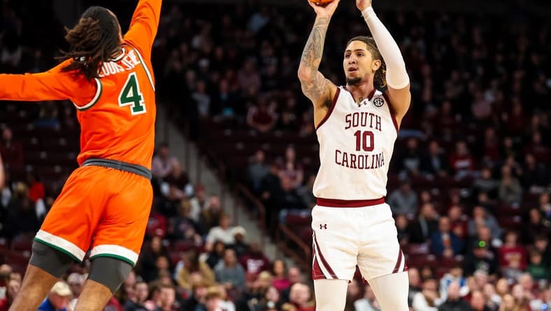 Dec 30, 2023; Columbia, South Carolina, USA; South Carolina Gamecocks guard Myles Stute (10) shoots over Florida A&M Rattlers guard Hantz Louis-Jeune (4) in the first quarter at Colonial Life Arena. Mandatory Credit: Jeff Blake-USA TODAY Sports
