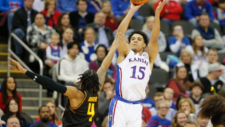 Kansas graduate senior guard Kevin McCullar Jr. (15) shoots for three against Wichita State during the second half of Saturday's game inside T-Mobile Center in Kansas City.