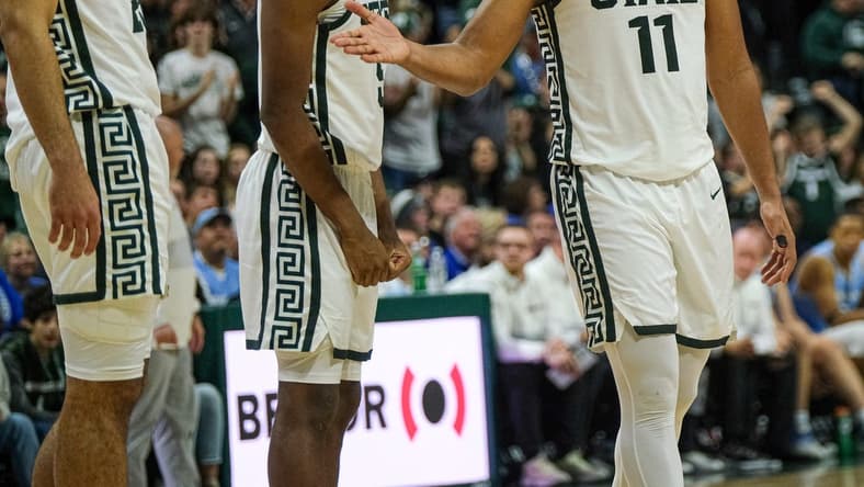 Michigan State players A.J. Hoggard (11), right, Tre Holloman (5), center, and Malik Hall (25) congratulate each other after a good play against Indiana State Saturday, Dec. 30, 2023. The Spartans won 87-75.