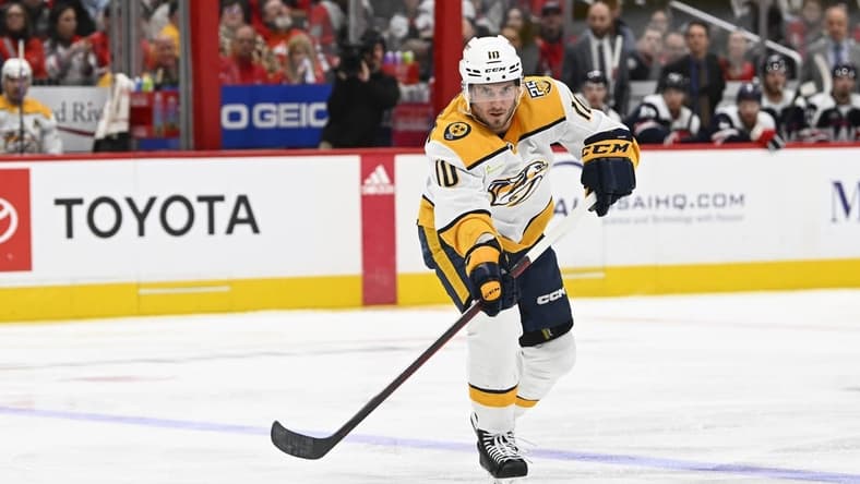 Dec 30, 2023; Washington, District of Columbia, USA; Nashville Predators center Colton Sissons (10) passes the puck against the Washington Capitals during the second period at Capital One Arena. Mandatory Credit: Brad Mills-USA TODAY Sports