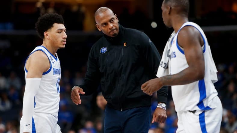 Memphis' Jahvon Quinerly (11) and David Jones (8) speak with head coach Penny Hardaway during the game between Austin Peay State University and University of Memphis at FedExForum in Memphis, Tenn., on Saturday, December 30, 2023.