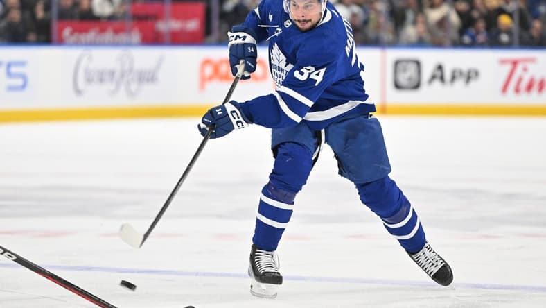 Dec 30, 2023; Toronto, Ontario, CAN; Toronto Maple Leafs forward Auston Matthews (34) shoots the puck against the Carolina Hurricanes in the first period at Scotiabank Arena. Mandatory Credit: Dan Hamilton-USA TODAY Sports