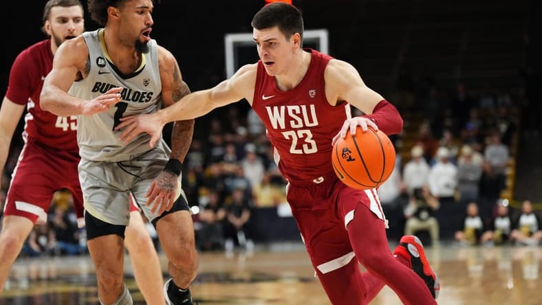Dec 31, 2023; Boulder, Colorado, USA; Washington State Cougars forward Andrej Jakimovski (23) drives at Colorado Buffaloes guard J'Vonne Hadley (1)in the first half at the CU Events Center. Mandatory Credit: Ron Chenoy-USA TODAY Sports