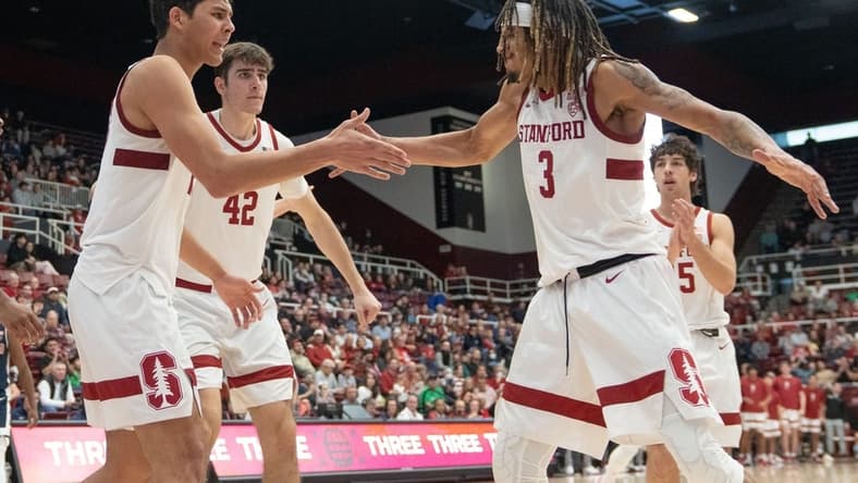 Dec 31, 2023; Stanford, California, USA; Stanford Cardinal guard Kanaan Carlyle (3) celebrates with forward Brandon Angel (23) and his teammates during the second half against the Arizona Wildcats at Maples Pavilion. Mandatory Credit: Stan Szeto-USA TODAY Sports