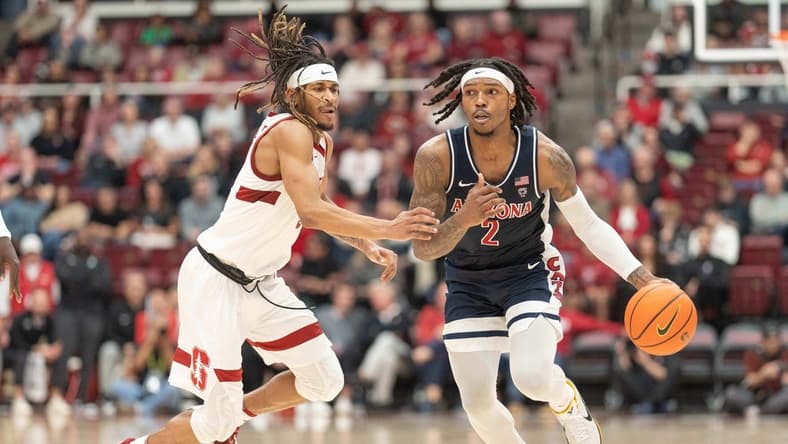 Dec 31, 2023; Stanford, California, USA; Arizona Wildcats guard Caleb Love (2) drives the ball during the second half against Stanford Cardinal guard Kanaan Carlyle (3) at Maples Pavilion. Mandatory Credit: Stan Szeto-USA TODAY Sports