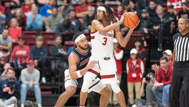 Dec 31, 2023; Stanford, California, USA; Stanford Cardinal guard Kanaan Carlyle (3) keeps the ball away from Arizona Wildcats guard Kylan Boswell (4) during the second half at Maples Pavilion. Mandatory Credit: Stan Szeto-USA TODAY Sports