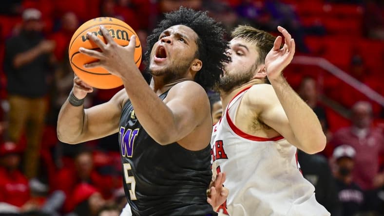 Dec 31, 2023; Salt Lake City, Utah, USA; Washington Huskies guard Sahvir Wheeler (5) takes a shot over Utah Utes guard Rollie Worster (25) during the second half at the the Jon M. Huntsman Center. Mandatory Credit: Christopher Creveling-USA TODAY Sports