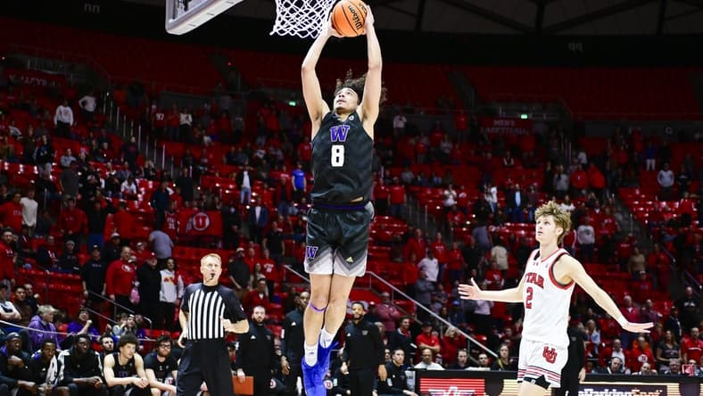 Dec 31, 2023; Salt Lake City, Utah, USA; Washington Huskies guard Nate Calmese (8) dunks over Utah Utes guard Cole Bajema (2) during the second half at the the Jon M. Huntsman Center. Mandatory Credit: Christopher Creveling-USA TODAY Sports
