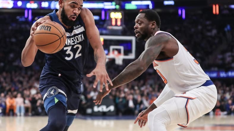 Jan 1, 2024; New York, New York, USA;  Minnesota Timberwolves center Karl-Anthony Towns (32) looks to drive past New York Knicks forward Julius Randle (30) in the first quarter at Madison Square Garden. Mandatory Credit: Wendell Cruz-USA TODAY Sports