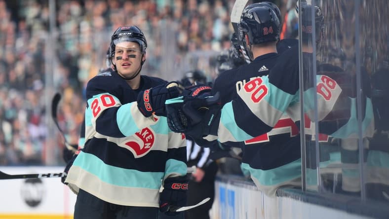 Jan 1, 2024; Seattle, Washington, USA; Seattle Kraken right wing Eeli Tolvanen (20) celebrates with the bench after scoring a goal against the Vegas Golden Knights during the first period in the 2024 Winter Classic ice hockey game at T-Mobile Park. Mandatory Credit: Steven Bisig-USA TODAY Sports
