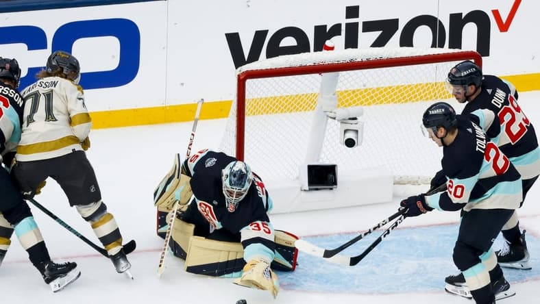 Jan 1, 2024; Seattle, Washington, USA; Seattle Kraken goaltender Joey Daccord (35) makes a save against the Vegas Golden Knights during the second period in the 2024 Winter Classic ice hockey game at T-Mobile Park. Mandatory Credit: Joe Nicholson-USA TODAY Sports