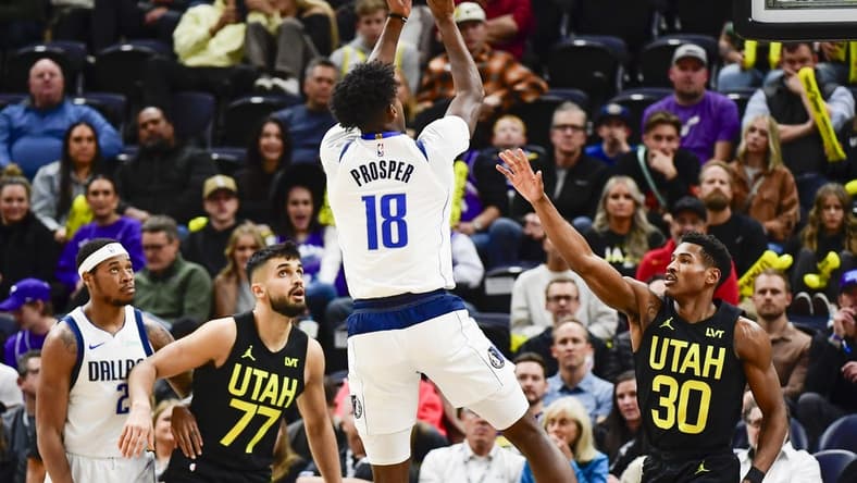 Jan 1, 2024; Salt Lake City, Utah, USA; Dallas Mavericks forward Olivier-Maxence Prosper (18) shoots over Utah Jazz guard Ochai Agbaji (30) during the second half at the Delta Center. Mandatory Credit: Christopher Creveling-USA TODAY Sports