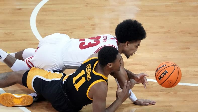 Jan 2, 2024; Madison, Wisconsin, USA; Wisconsin Badgers guard Chucky Hepburn (23) and Iowa Hawkeyes guard Tony Perkins (11) go after a loose ball during the first half at the Kohl Center. Mandatory Credit: Kayla Wolf-USA TODAY Sports