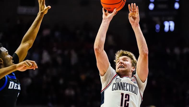 Jan 2, 2024; Storrs, Connecticut, USA; Connecticut Huskies guard Cam Spencer (12) shoot the ball against the DePaul Blue Demons in the second half at Harry A. Gampel Pavilion. Mandatory Credit: David Butler II-USA TODAY Sports