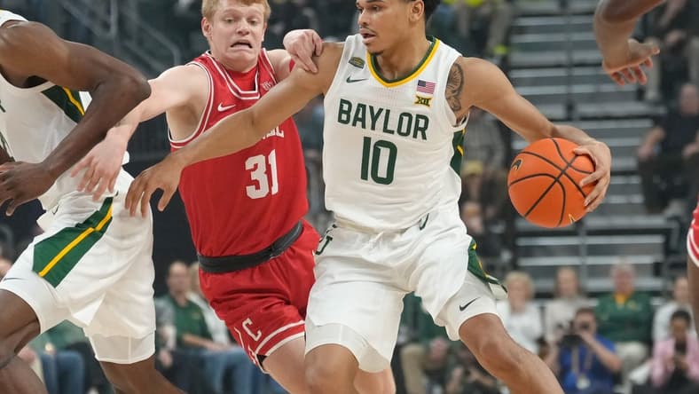 Jan 2, 2024; Waco, Texas, USA; Baylor Bears guard RayJ Dennis (10) controls the ball against Cornell Big Red guard Cooper Noard (31) during the first half at Paul and Alejandra Foster Pavilion. Mandatory Credit: Chris Jones-USA TODAY Sports