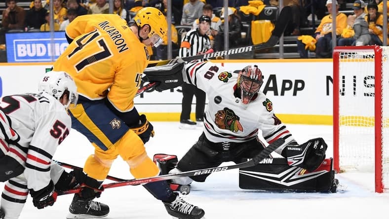 Jan 2, 2024; Nashville, Tennessee, USA; Chicago Blackhawks goaltender Arvid Soderblom (40) waits to block a shot by Nashville Predators right wing Michael McCarron (47) during the first period at Bridgestone Arena. Mandatory Credit: Christopher Hanewinckel-USA TODAY Sports