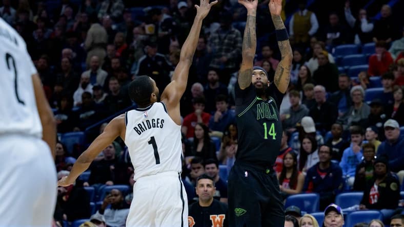 Jan 2, 2024; New Orleans, Louisiana, USA; New Orleans Pelicans forward Brandon Ingram (14) shoots a three point basket against Brooklyn Nets forward Mikal Bridges (1) at Smoothie King Center. Mandatory Credit: Matthew Hinton-USA TODAY Sports