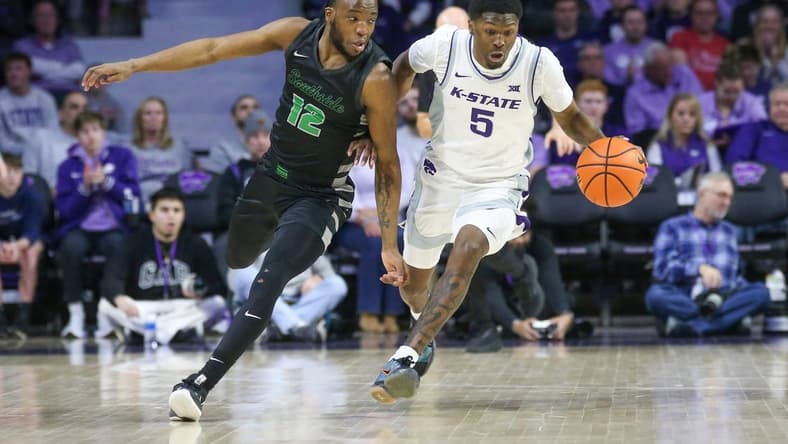 Jan 2, 2024; Manhattan, Kansas, USA; Kansas State Wildcats guard Cam Carter (5) brings the ball up court against Chicago State Cougars guard Brent Davis (12) during the first half at Bramlage Coliseum. Mandatory Credit: Scott Sewell-USA TODAY Sports