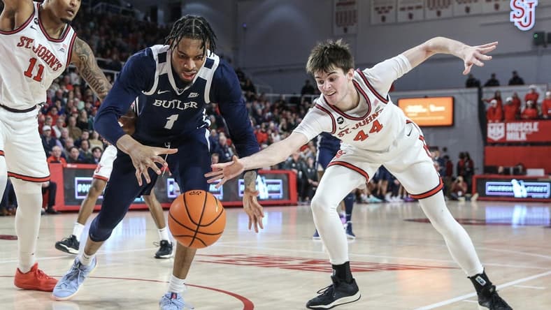 Jan 2, 2024; Queens, New York, USA; Butler Bulldogs forward Jalen Thomas (1) and St. John's Red Storm forward Brady Dunlap (44) fight for a loose ball in the first half at Carnesecca Arena. Mandatory Credit: Wendell Cruz-USA TODAY Sports