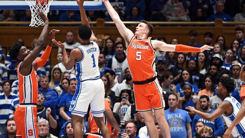 Jan 2, 2024; Durham, North Carolina, USA; Duke Blue Devils guard Caleb Foster (1) shoots between Syracuse Orange guard Justin Taylor (5) and center Naheem McLeod (10) during the first half at Cameron Indoor Stadium. Mandatory Credit: Rob Kinnan-USA TODAY Sports