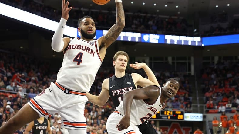 Jan 2, 2024; Auburn, Alabama, USA; Auburn Tigers forward Johni Broome (4) controls a rebound during the first half against the Pennsylvania Quakers at Neville Arena. Mandatory Credit: John Reed-USA TODAY Sports