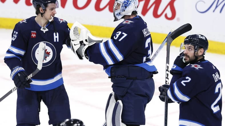 Jan 2, 2024; Winnipeg, Manitoba, CAN; Winnipeg Jets center Mark Scheifele (55) and Winnipeg Jets goaltender Connor Hellebuyck (37) celebrate their victory over the Tampa Bay Lightning at Canada Life Centre. Mandatory Credit: James Carey Lauder-USA TODAY Sports