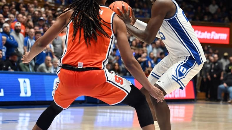 Jan 2, 2024; Durham, North Carolina, USA; Duke Blue Devils forward Mark Mitchell (25) controls the ball in front of Syracuse Orange forward Maliq Brown (1) during the second half at Cameron Indoor Stadium. The Blue Devils won 86-66. Mandatory Credit: Rob Kinnan-USA TODAY Sports