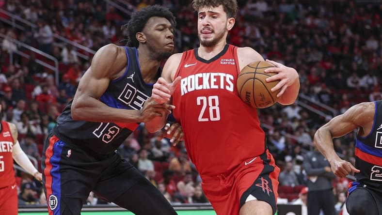 Jan 1, 2024; Houston, Texas, USA; Houston Rockets center Alperen Sengun (28) controls the ball as Detroit Pistons center James Wiseman (13) defends during the game at Toyota Center. Mandatory Credit: Troy Taormina-USA TODAY Sports