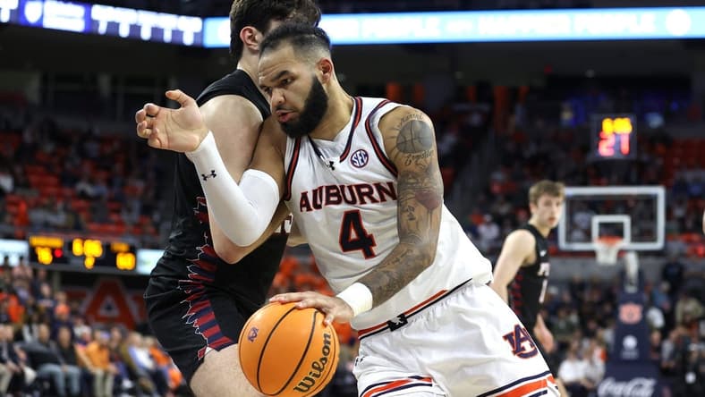 Jan 2, 2024; Auburn, Alabama, USA; Auburn Tigers forward Johni Broome (4) is the focus of Arkansas' defense this weekend. Mandatory Credit: John Reed-USA TODAY Sports