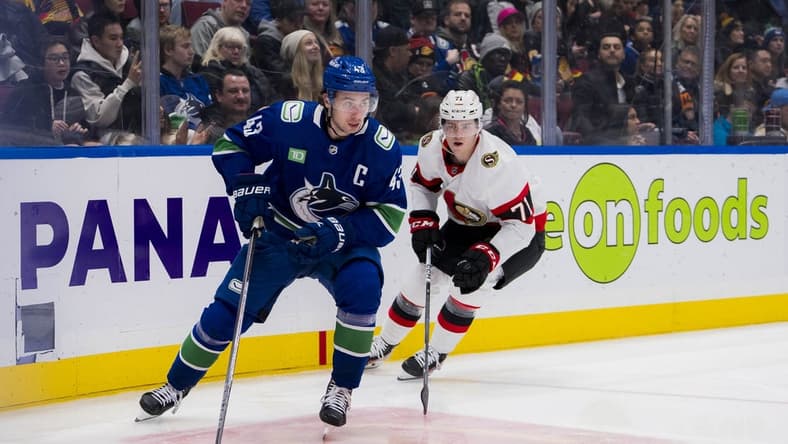 Jan 2, 2024; Vancouver, British Columbia, CAN; Ottawa Senators forward Ridly Greig (71) pursues Vancouver Canucks defenseman Quinn Hughes (43) in the second period at Rogers Arena. Mandatory Credit: Bob Frid-USA TODAY Sports