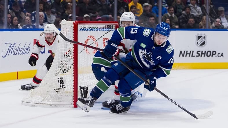 Jan 2, 2024; Vancouver, British Columbia, CAN; Ottawa Senators defenseman Erik Brannstrom (26) and Vancouver Canucks defenseman Quinn Hughes (43) skates after the loose puck in the second period at Rogers Arena. Mandatory Credit: Bob Frid-USA TODAY Sports