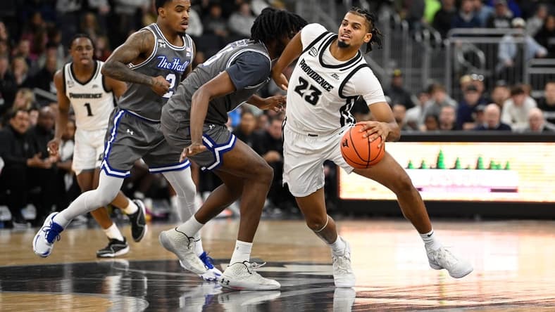 Jan 3, 2024; Providence, Rhode Island, USA; Providence Friars forward Bryce Hopkins (23) drives the ball through Seton Hall Pirates center Jaden Bediako (15) during the first half at Amica Mutual Pavilion. Mandatory Credit: Eric Canha-USA TODAY Sports