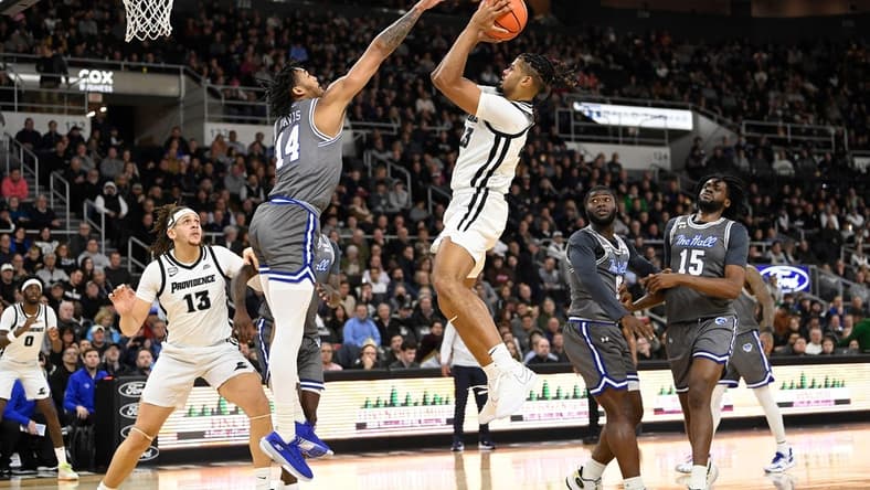 Jan 3, 2024; Providence, Rhode Island, USA; Providence Friars forward Bryce Hopkins (23) shoots the ball over Seton Hall Pirates guard Dre Davis (14) during the first half at Amica Mutual Pavilion. Mandatory Credit: Eric Canha-USA TODAY Sports