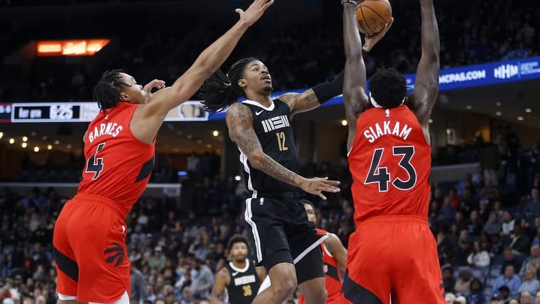 Jan 3, 2024; Memphis, Tennessee, USA; Memphis Grizzlies guard Ja Morant (12) drives to the basket between Toronto Raptors forward Scottie Barnes (4) and forward Pascal Siakam (43) during the first half at FedExForum. Mandatory Credit: Petre Thomas-USA TODAY Sports