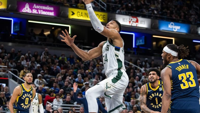 Jan 3, 2024; Indianapolis, Indiana, USA; Milwaukee Bucks forward Giannis Antetokounmpo (34) shoots the ball while Indiana Pacers center Myles Turner (33) defends in the second quarter at Gainbridge Fieldhouse. Mandatory Credit: Trevor Ruszkowski-USA TODAY Sports