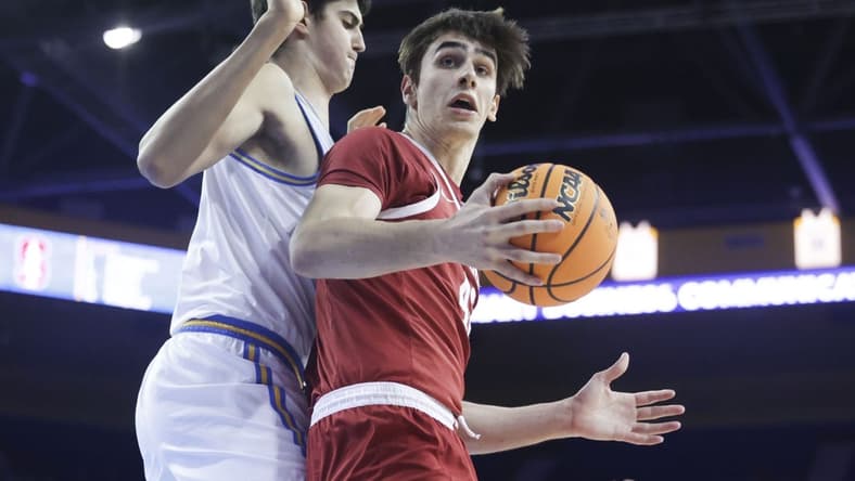Jan 3, 2024; Los Angeles, California, USA; Stanford Cardinal forward Maxime Raynaud (42) catches the ball as UCLA center Aday Mara (15) defends during the first half at Pauley Pavilion presented by Wescom. Mandatory Credit: Yannick Peterhans-USA TODAY Sports