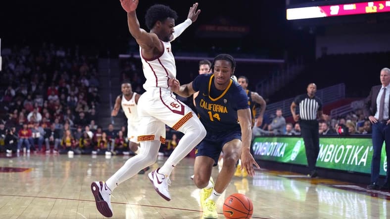 Jan 3, 2024; Los Angeles, California, USA; California Golden Bears forward Grant Newell (14) dribbles against Southern California Trojans guard Bronny James (6) in the first half at Galen Center. Mandatory Credit: Kirby Lee-USA TODAY Sports