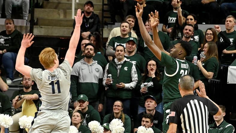 Jan 4, 2024; East Lansing, Michigan, USA; Michigan State Spartans forward Xavier Booker (34) shoots past Penn State Nittany Lions forward Leo O'Boyle (11) during the first half at Jack Breslin Student Events Center. Mandatory Credit: Dale Young-USA TODAY Sports