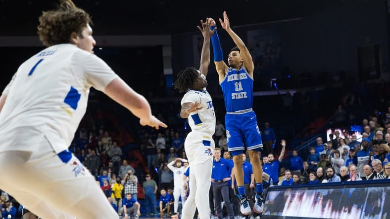 Jan 4, 2024; Tulsa, Oklahoma, USA; Memphis Tigers guard Jahvon Quinerly (11) hits a three point shot over Tulsa Golden Hurricane forward Carlous Williams (12) for the go ahead and eventual game winner against the Tulsa Golden Hurricane at Reynolds Center. The Memphis Tigers won the game 78-75. Mandatory Credit: Brett Rojo-USA TODAY Sports