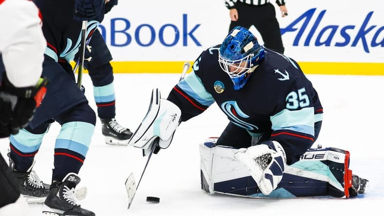 Jan 4, 2024; Seattle, Washington, USA; Seattle Kraken goaltender Joey Daccord (35) collects the puck during the first period against the Ottawa Senators at Climate Pledge Arena. Mandatory Credit: Joe Nicholson-USA TODAY Sports