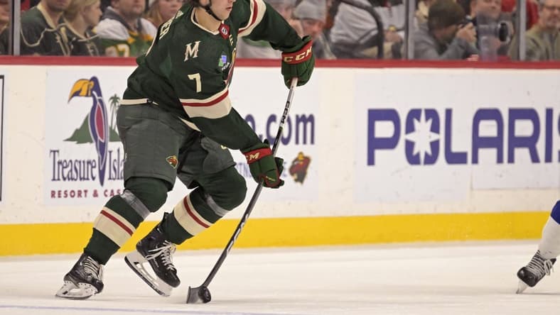 Jan 4, 2024; Saint Paul, Minnesota, USA; Minnesota Wild defenseman Brock Faber (7) makes a pass against the Tampa Bay Lightning during the third period at Xcel Energy Center. Mandatory Credit: Nick Wosika-USA TODAY Sports