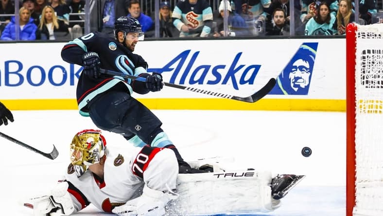 Jan 4, 2024; Seattle, Washington, USA; Seattle Kraken left wing Tomas Tatar (90) scores a goal against Ottawa Senators goaltender Joonas Korpisalo (70) during the second period at Climate Pledge Arena. Mandatory Credit: Joe Nicholson-USA TODAY Sports